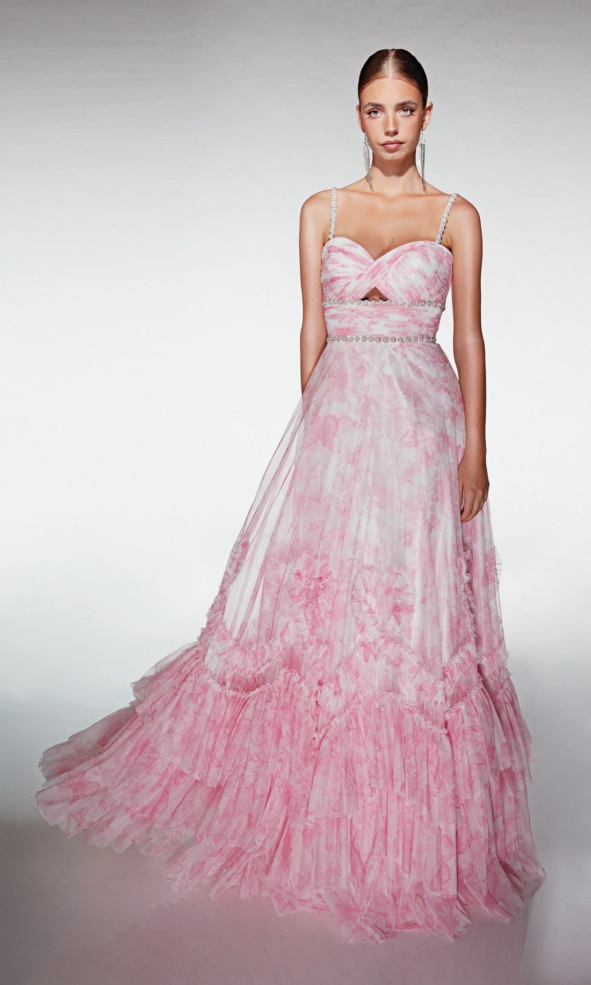 A woman wears the Alyce 62063 long formal dress in pink, featuring thin straps, a fitted bodice, and a layered ruffled skirt—an elegant prom choice.